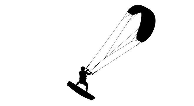 Silhouette of a kiteboarder surfing with a large kite