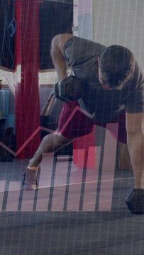 Vertical video: Man from plank grip alternating DBs rows and pushups while HUD tracking training