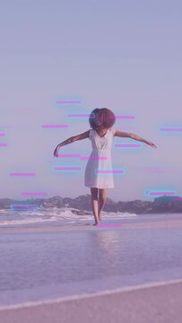 Vertical video: Woman entering surf walking modeling fashion with glitch drifting over her