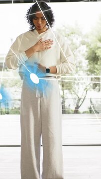 Vertical video: Nonbinary person tracking AR cue at belly, orb or grid pulsing, guiding breath, heal