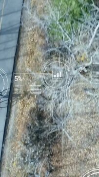 Vertical video: Drone tracking teen cyclist on rural road, HUD overlaying map, orders, logistics