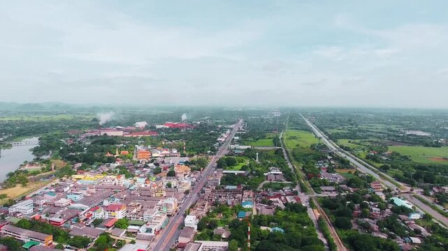 Morning aerial video of Lamphun city showcasing peaceful small-town atmosphere, traditional Thai architecture, and scenic urban landscape captured in soft early light.