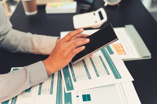 Business professionals are discussing charts and graphs that display successful results in order to analyze financial reports, plan strategies, and improve efficiency.
