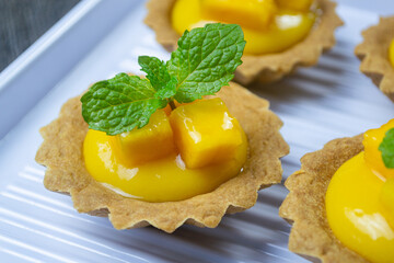 pie mangga or mango pie topped with fresh mango cubes and mint leaves © Muhammad Senopati