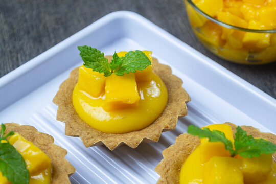 pie mangga or mango pie topped with fresh mango cubes and mint leaves