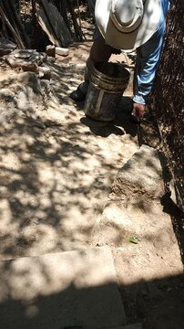 Worker Carrying and Pouring Cement Mix on Repair Site