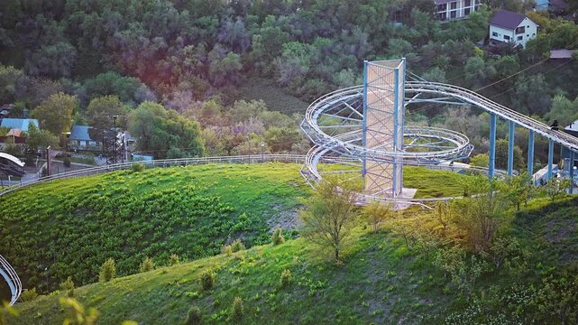 Scenic view of a mountain roller coaster track during golden hour