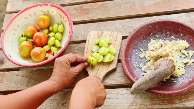 Person preparing traditional indonesian food by hand