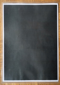 Black Paper Sheet Mockup on Wooden Floor