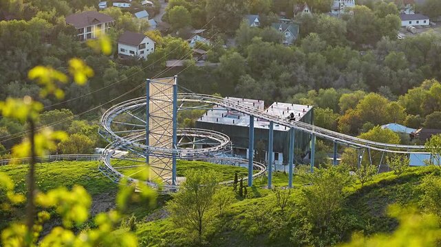 Scenic view of a mountain roller coaster track during golden hour