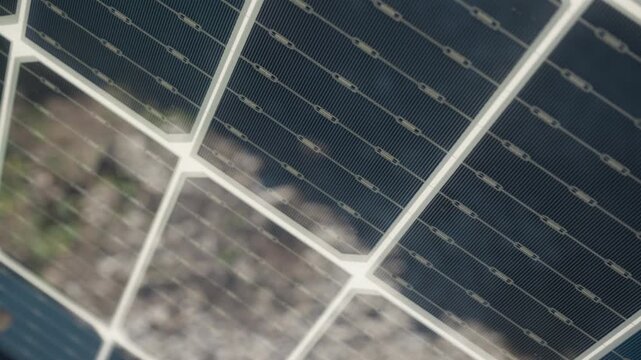 Bifacial photovoltaic solar cell texture in close up. Detailed view of translucent panel back side for renewable energy generation showing electrical grid on silicon module surface.