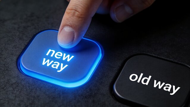A finger presses a glowing blue button labeled new way next to an old way button on a dark surface.