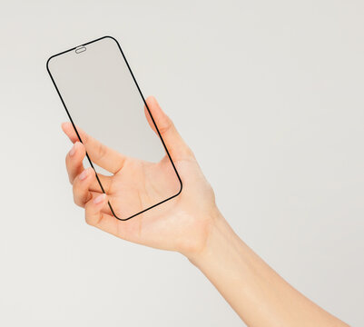 Clipping path, Gesture of hand holding smartphone with a blank screen, for mobile app mockup and digital technology concept.