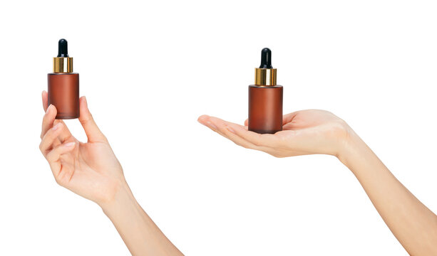 Clipping path, Hands holding glass dropper bottle and using pipette with liquid serum isolated on white background for skincare and cosmetic concept.