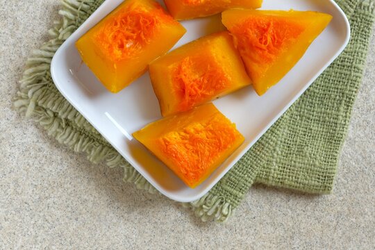 A plate of  steamed pumpkin.   Healthy steamed organic squash for a vegan diet, nutritious superfood snack. Labu kukus