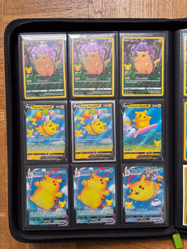 Hamburg, Germany - 04042026: several pikachu cards from the 25th anniversary set in a binder behind plastic foil.
