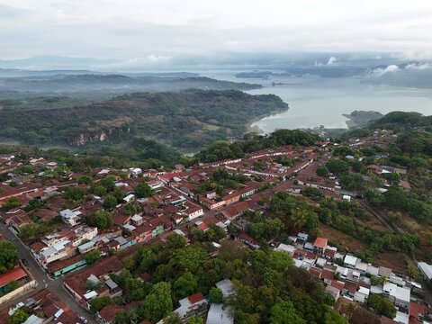 This is an aerial of Suchitoto, with Lago Suchitl&aacute;n in the background. From sacred streets to untamed landscapes, this is El Salvador. Traditional central American homes feature in this wide shot