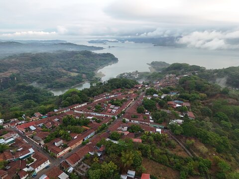 This is an aerial of Suchitoto, with Lago Suchitl&aacute;n in the background. From sacred streets to untamed landscapes, this is El Salvador. Traditional central American homes feature in this wide shot