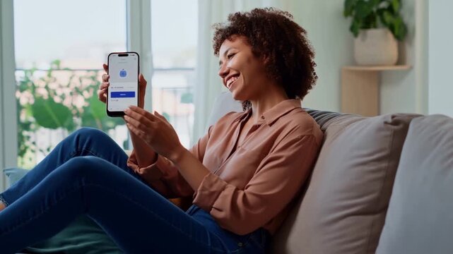 Happy female enjoys casual chat on mobile device at home chat creates positive emotions instantly chat connects people remotely chat interface looks user friendly for everyone here today.