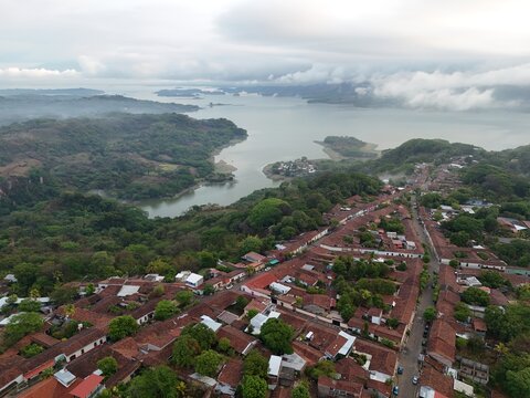 This is an aerial of Suchitoto, with Lago Suchitl&aacute;n in the background. From sacred streets to untamed landscapes, this is El Salvador. Traditional central American homes feature in this wide shot