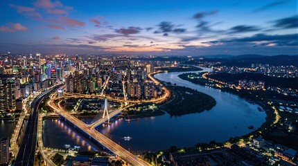 Fototapeta premium An aerial view of a bridge over a river at night.