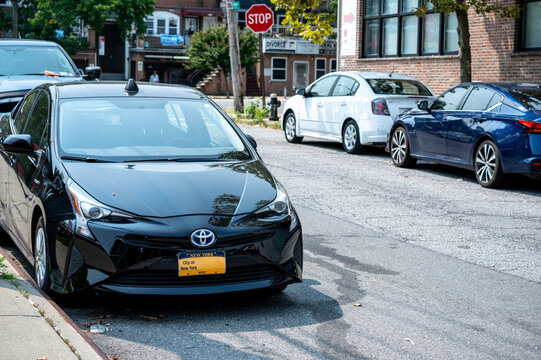 New york, usa august 16,2024. Black toyota prius hybrid car parked on a urban street in new york city, demonstrating daily city life and transportation