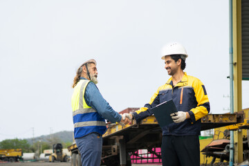 Fototapeta premium Engineer and worker feel happy when they achieve their goals, They shouted and shake hands with joy at containers cargo site, Success and teamwork concepts