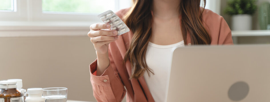Mindful Health Habits: Engaging in Informed Wellness - A Person Deliberates Supplement Information Before Consumption for Optimal Nutritional Awareness and Personal Well-being.