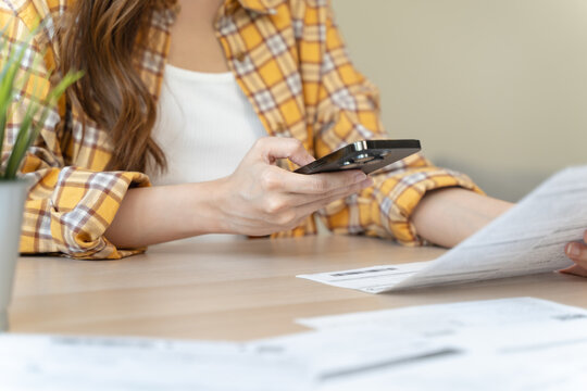 Digital Finance at Fingertips: Close-Up Hands Seamlessly Handling Bills and Smartphone for Efficient Online Payment and Financial Management