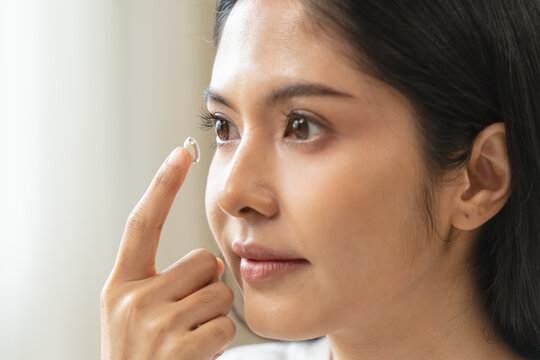 Optimise vision by contact lens, Close-up of woman face during insert contact lens to her eyes.