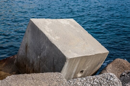 Concrete breakwater block standing firm by the sea