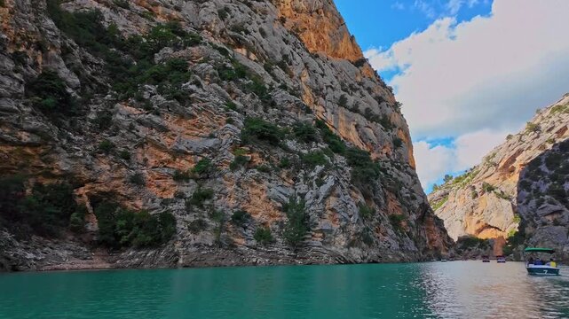 Boat trip on turquoise water of mountain canyon, Verdon Gorge in french Alps, Provence France. Near Aiguines. Canyon is about 25 kilometres long and up to 700 metres deep.