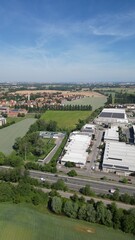 Obraz premium Aerial Industrial Landscape: Expansive aerial perspective reveals a vibrant industrial park nestled amidst a serene rural landscape, harmoniously blending industry with nature's embrace.