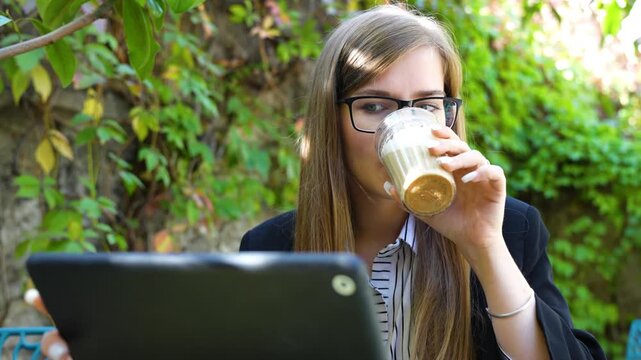 The girl is negotiating and drinking coffee