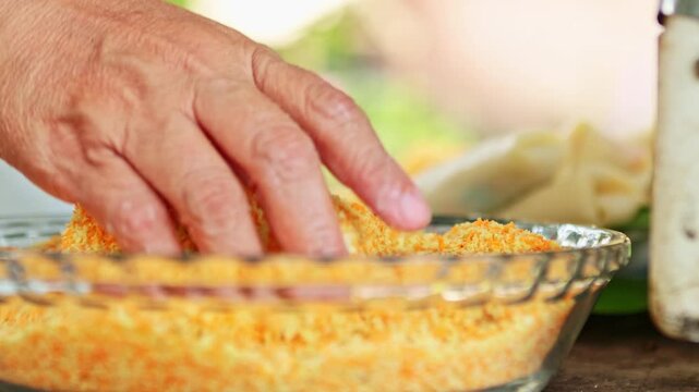 Chef coating delicious indonesian food with breadcrumbs