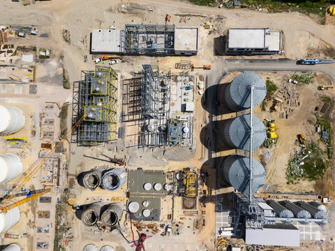 Construction site of a modern agricultural complex with silos, grain elevator and storage terminal. Aerial view