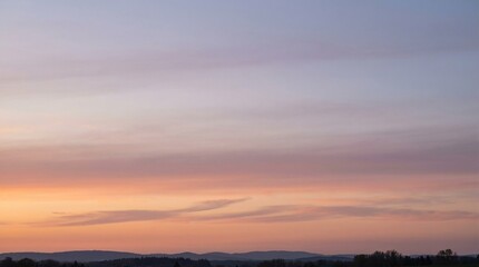 Fototapeta premium Beautiful Sunset Sky with Pastel Pink and Orange Clouds over Hills