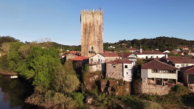 Lapela tower a medieval castle reflecting in the calm waters of minho river