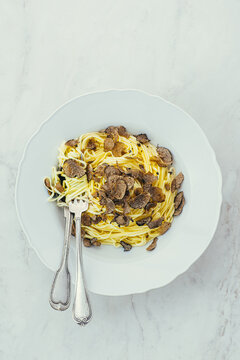 White truffle pasta Tajari, top view. Autumn gourmet cuisine of Piedmont, Northern Italy, Spain and France, copy space 