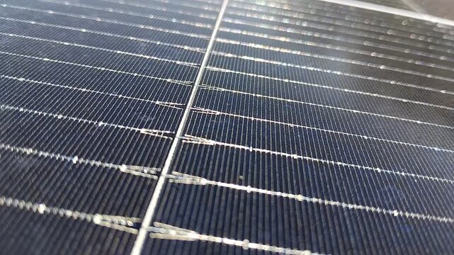 Close-up of renewable energy solar panel surface showing intricate grid lines