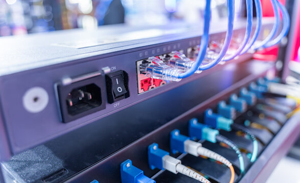 Fiber Optical cables connected to an optic ports and Network cables connected to ethernet ports
