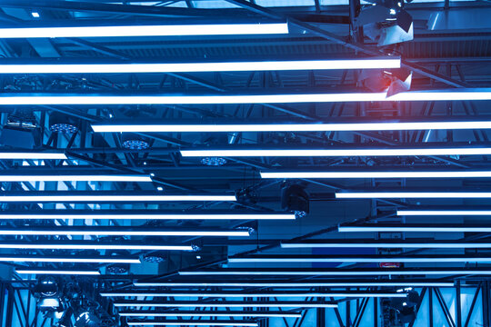 Directional LED lights on rails under the ceiling in a modern warehouse, shopping center building, office or other commercial real estate object.