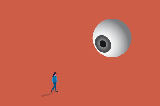 Business woman walking under a giant floating eyeball, representing corporate surveillance, oversight, and public scrutiny