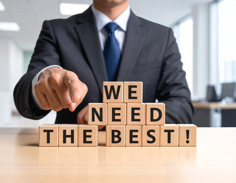 We need the best! - Geschäftsmann zeigt auf den Text "We need the best!"