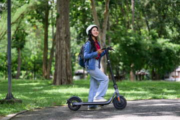 Young student riding electric scooter in a park © PaeGAG