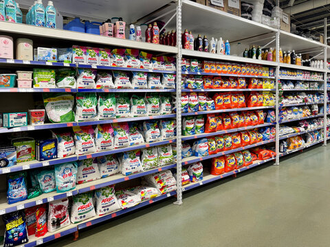Barnaul, Russia, 06.06.2025: Supermarket aisle with fully stocked shelves of laundry detergent powder bags including Ariel, Tide, and Persil brands in a retail store.
