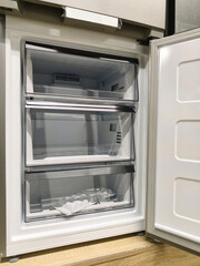 Fototapeta premium Large fridge with open freezer door, now available in a major supermarket