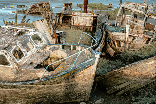 Wreck of a wooden fishing boat abandoned on the shore - France