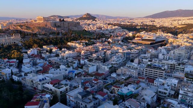 Aerial  Video of Athens Cityscape at Sunset featuring Acropolis, Parthenon, and Odeon of Herodes Atticus, and Lycabettus Hill. 