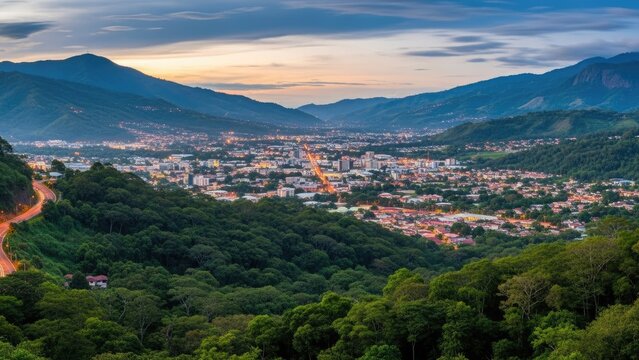panoramic cityscape at dusk with mountain backdrop and golden lights